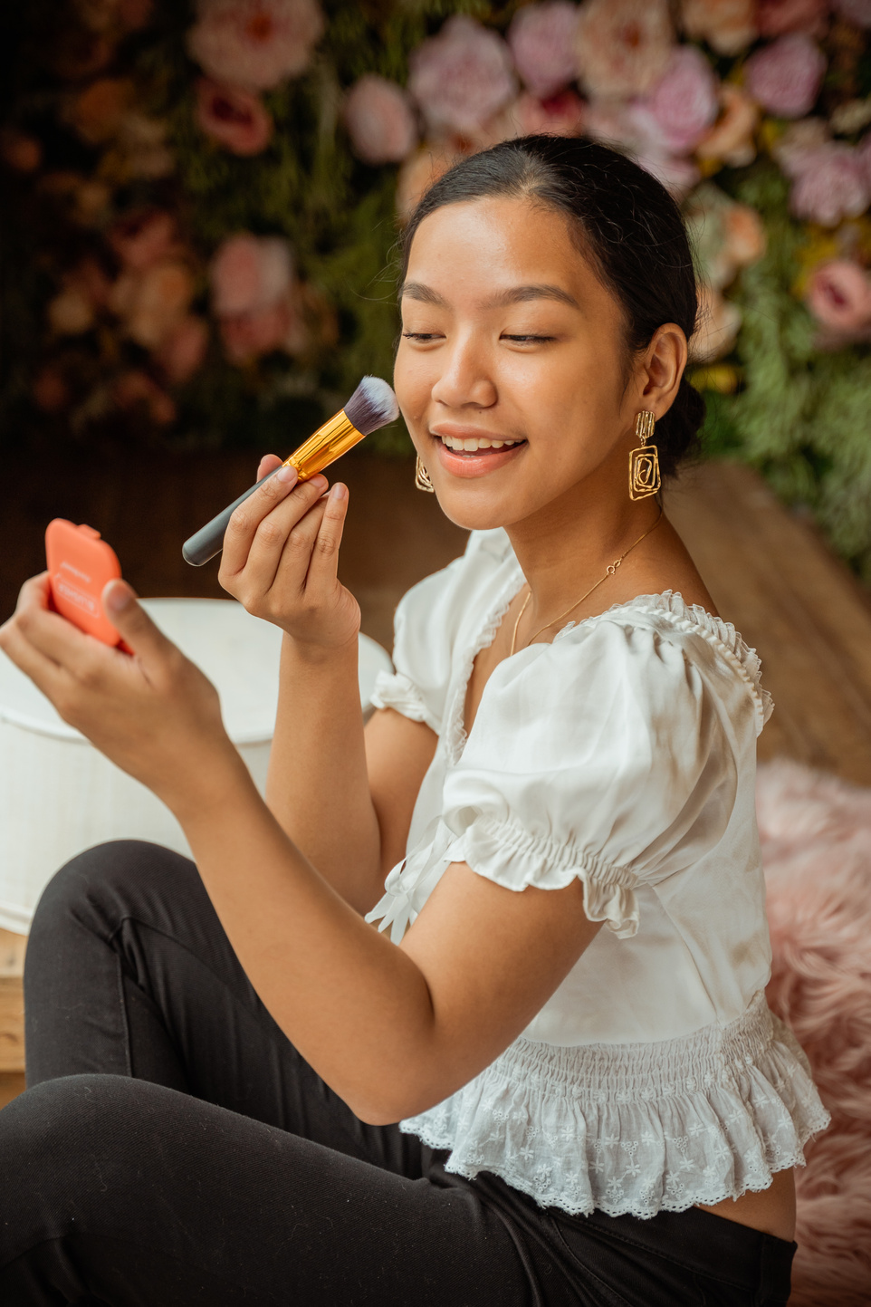 Young Woman Putting on Makeup Product